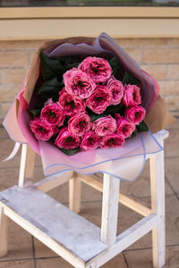 Close-up of pink rose on table