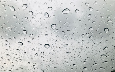 Full frame shot of raindrops on glass window