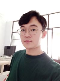 Portrait of young man against wall