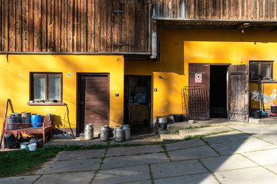 Empty footpath by buildings in city