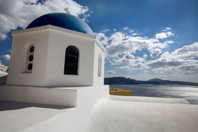 Building by sea against sky