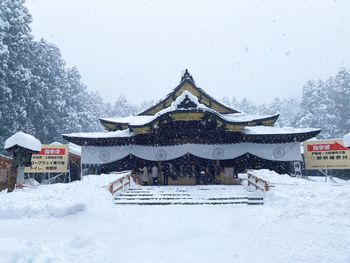 Snow covered building against sky