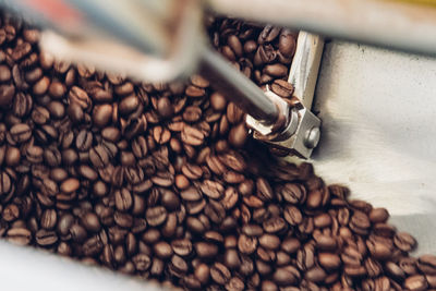 Directly above shot of roasted coffee beans on metal sheet