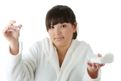 Portrait of woman holding hands over white background