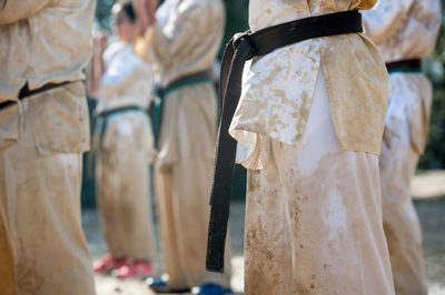 Midsection of people practicing karate