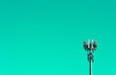Communications tower against green background