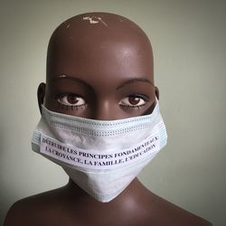 Close-up of mannequin with mask and quotes