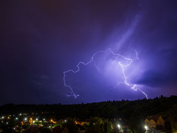 Low angle view of lightning in sky at night