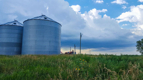 Panoramic view of agricultural field against sky