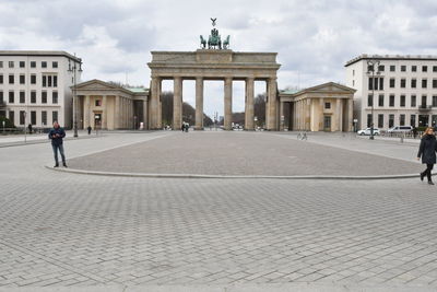 People walking in front of historical building