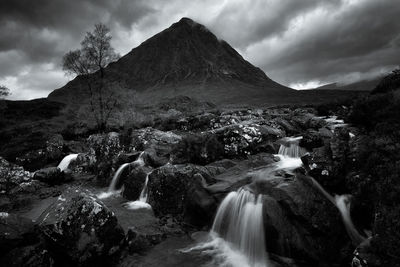 Scenic view of waterfall against sky