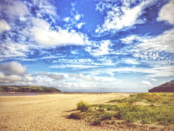 Scenic view of landscape against cloudy sky