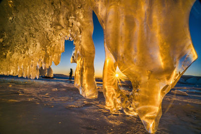 Digital composite image of icicles on beach against sky