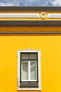 Low angle view of yellow window on building