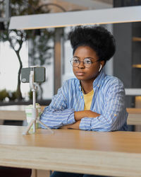 Portrait of woman sitting on table