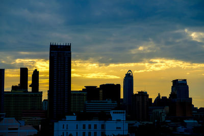 Modern buildings in city against sky during morning