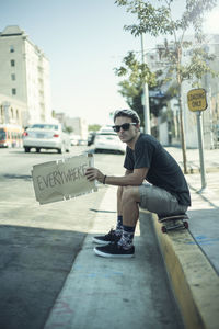 Young man wearing sunglasses in city