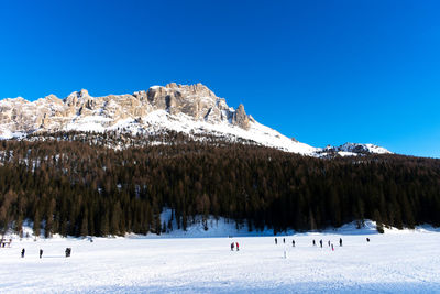 Scenic view of snowcapped mountains against clear blue sky