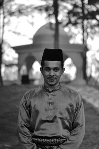 Portrait of young man wearing hat standing outdoors