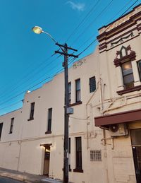 Low angle view of buildings against blue sky