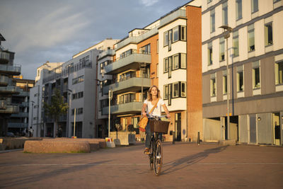Woman cycling in city