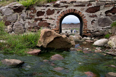 Old stone wall by rocks