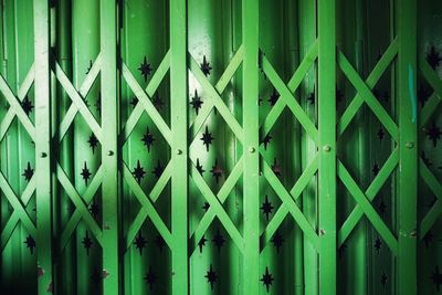 Full frame shot of closed metal gate against wall