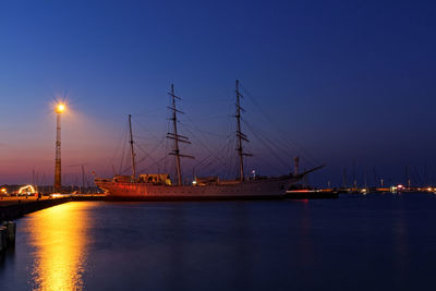 Sailboats in marina at sunset