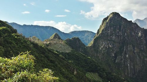 Scenic view of mountains against cloudy sky