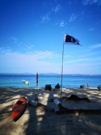 Scenic view of beach against blue sky