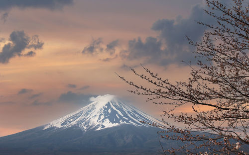 Scenic view of snowcapped mountains against sky during sunset