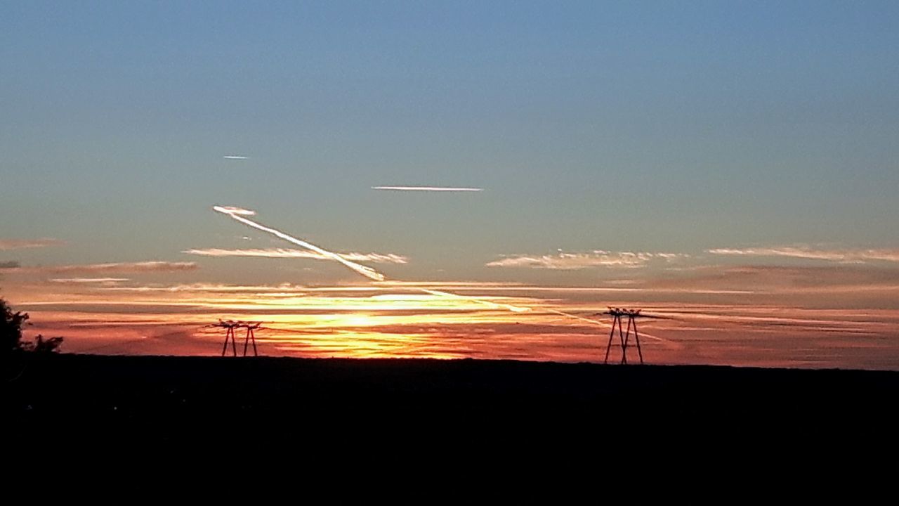 LOW ANGLE VIEW OF SILHOUETTE WINDMILLS AGAINST SKY