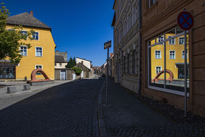 Street amidst buildings against sky