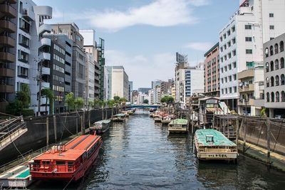 Boats in canal along buildings