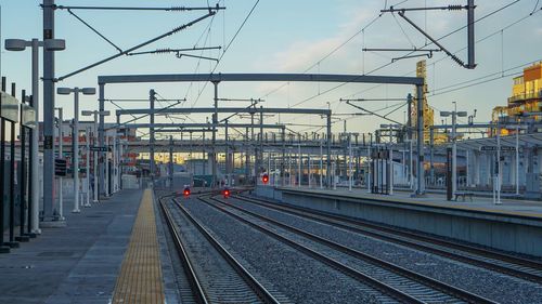 Railroad tracks in city against sky