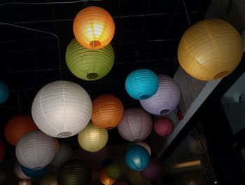 Low angle view of illuminated lanterns hanging on ceiling