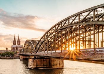 Bridge over river at sunset