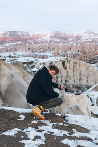 Side view of a dog on snow