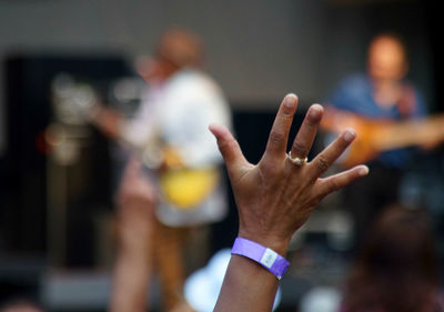 Cropped image of hand at music concert