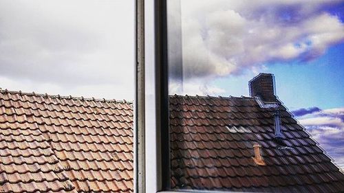 Low angle view of building against cloudy sky