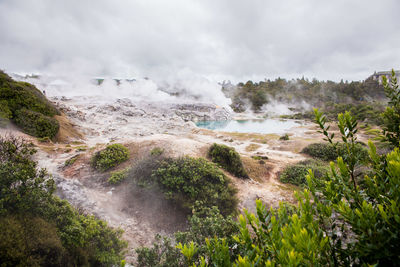 Scenic view of waterfall against sky