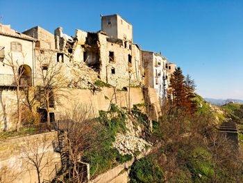 Low angle view of old building against clear blue sky