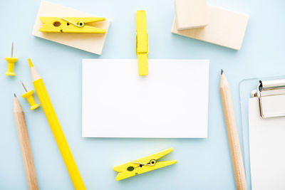 High angle view of yellow pencils on paper