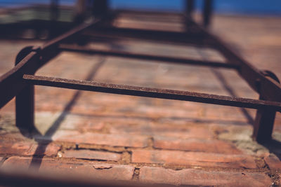 Low angle view of rusty ladder on brick wall