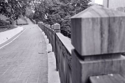 Empty footpath by fence