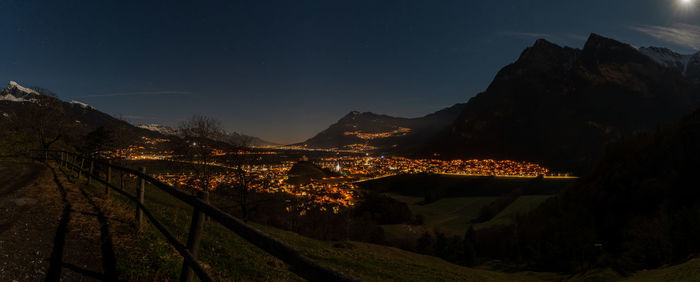 Panoramic view of illuminated mountains against sky at night