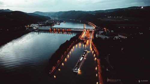 View of illuminated bridge over river