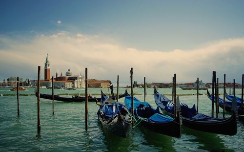 Boats in river against sky