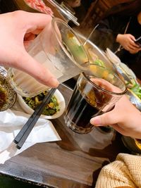 Midsection of a woman drinking glass