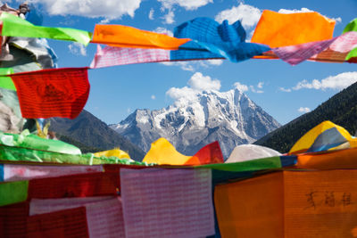 Multi colored flags against mountains